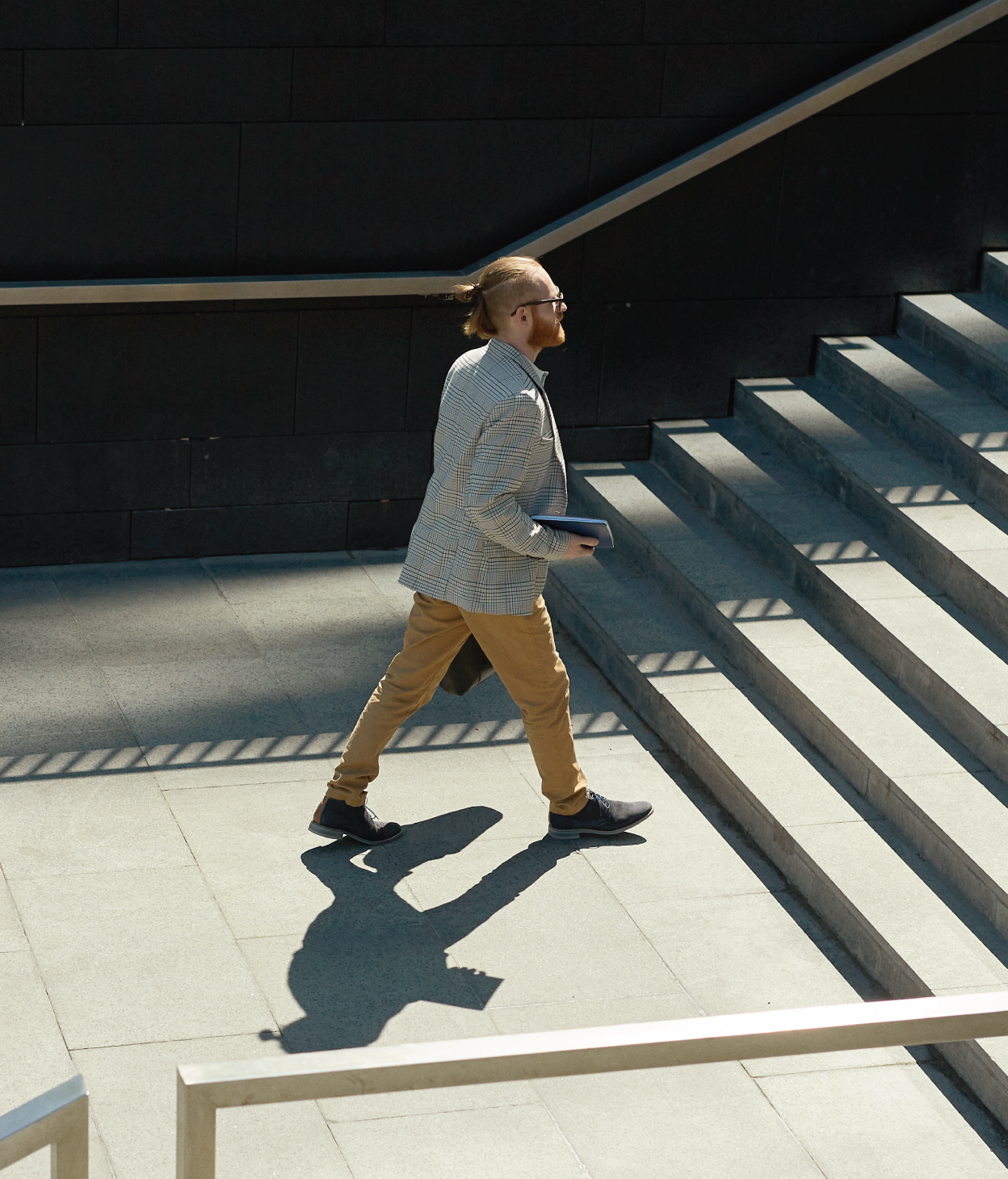 Businessman walking up a set of stairs.