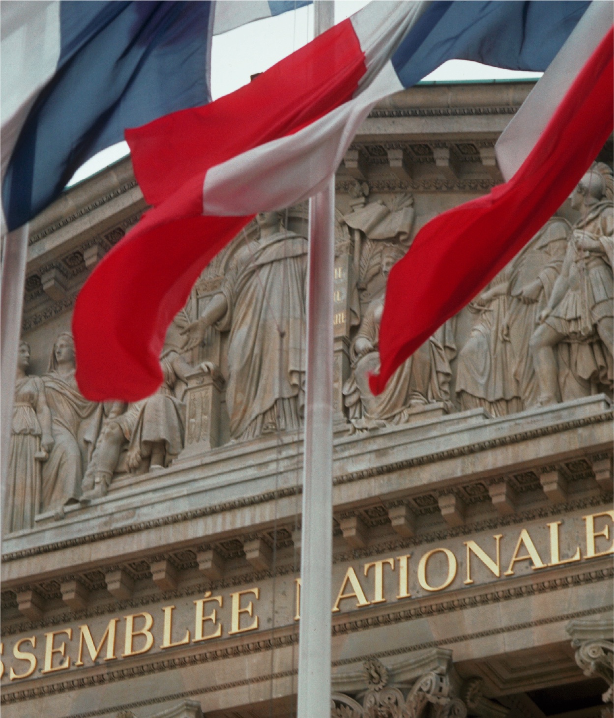 French flags in front of the Palais Bourbon in Paris