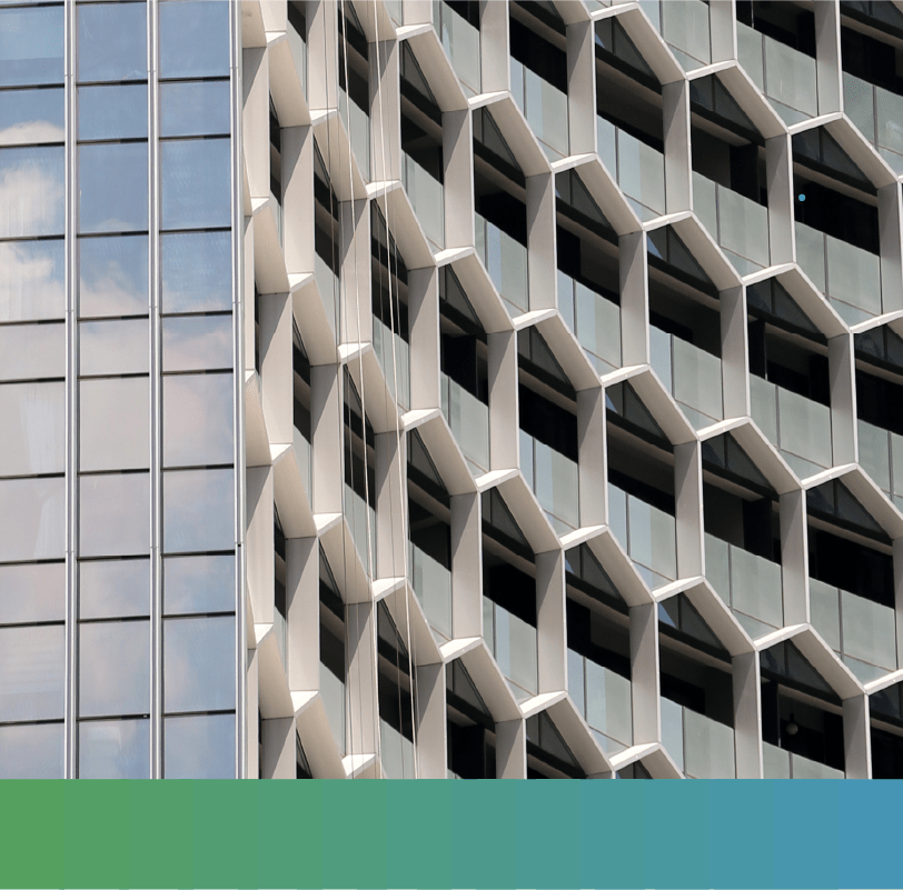 Curved office building façade with hexagonal frames over the windows.