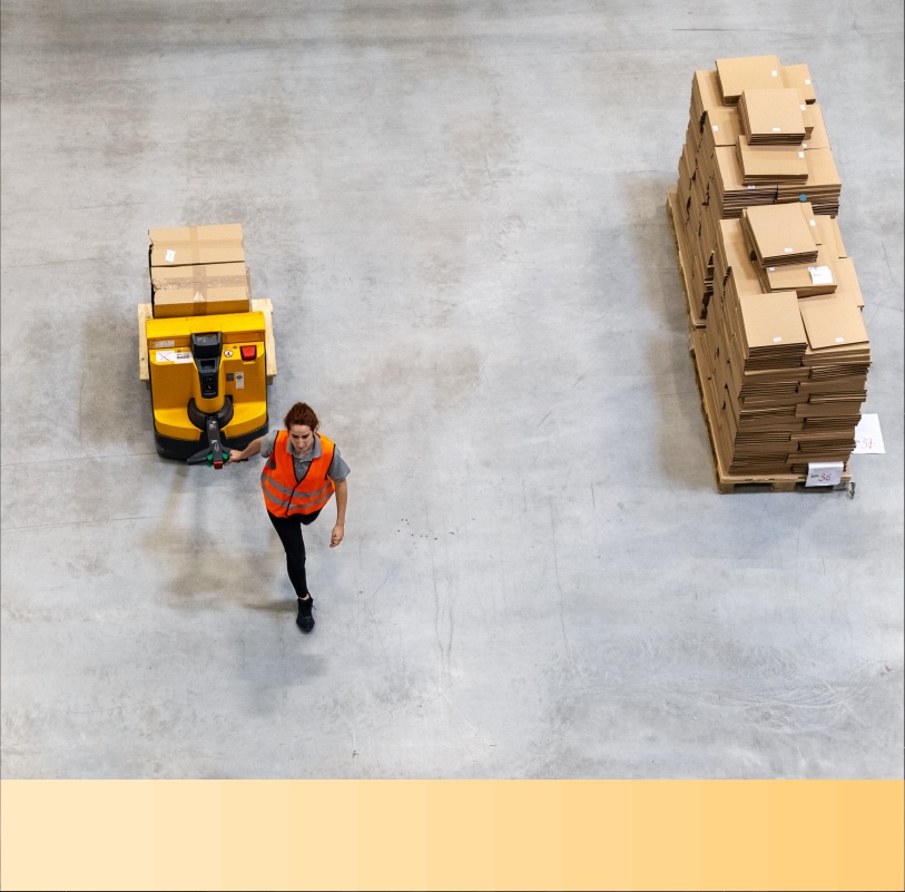 Aerial view of a warehouse employee moving packages on a pallet