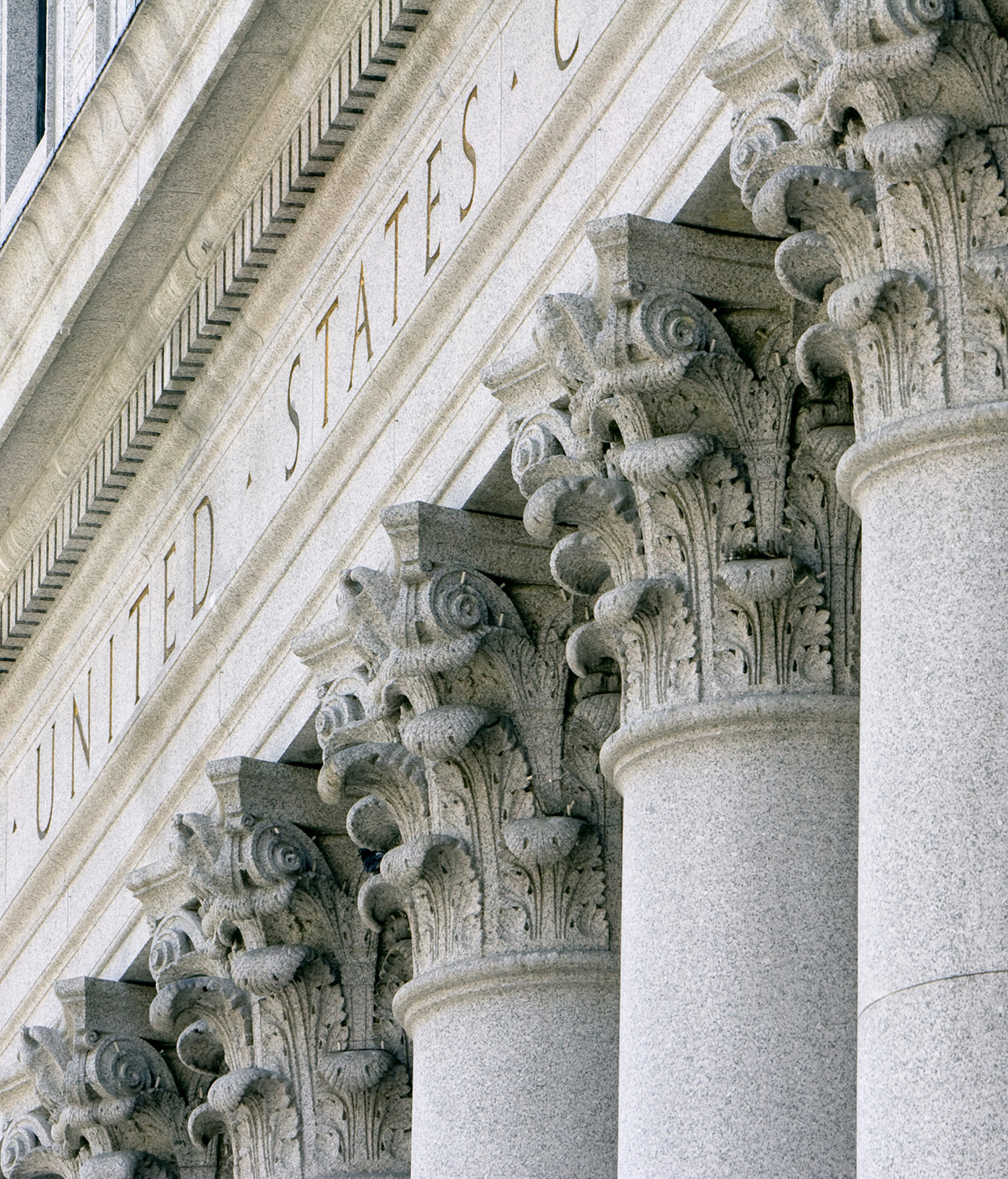 photo of a close-up shot of stone classical columns on a United States federal government building.