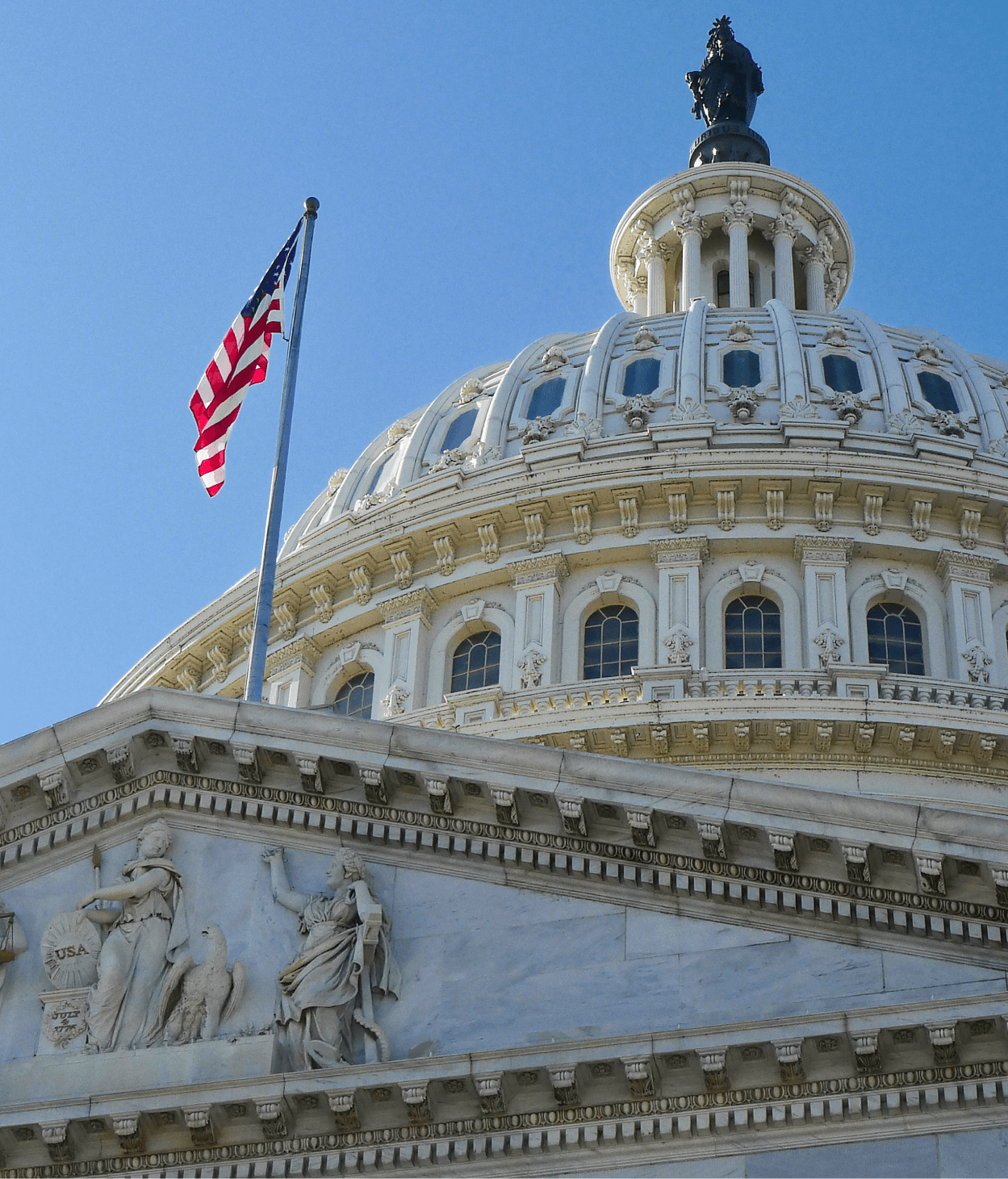photo of the United States capitol building where the viewer is looking up at the east front facade towards the Rotunda.