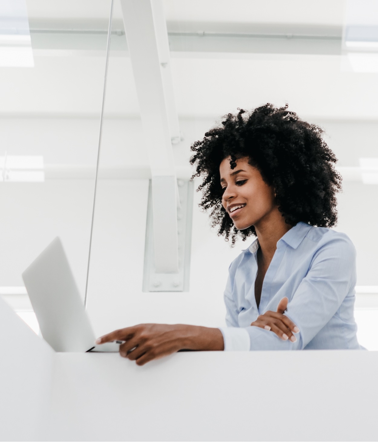 Woman works on her laptop at her office desk.