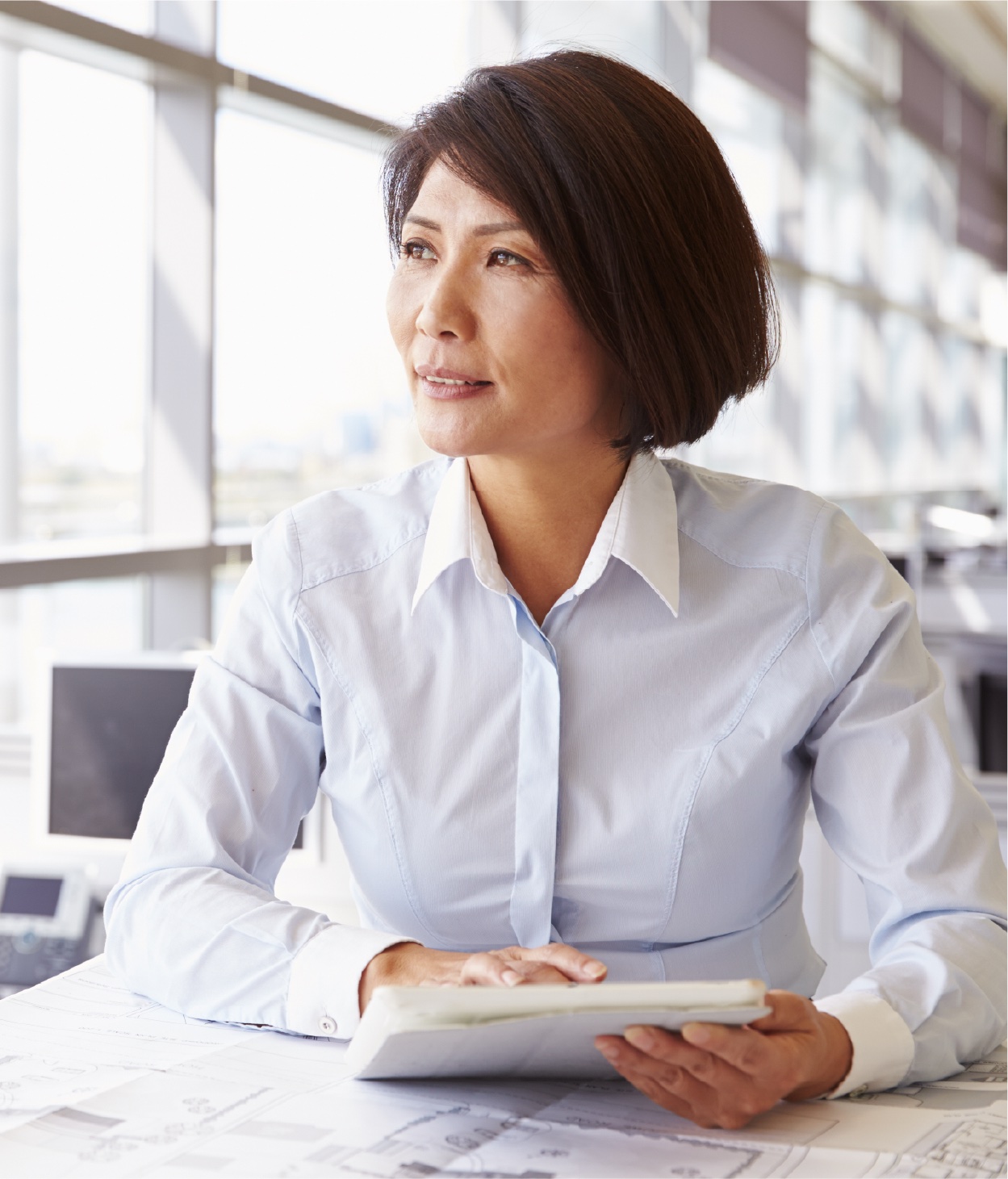 Woman works on a blueprint in her office