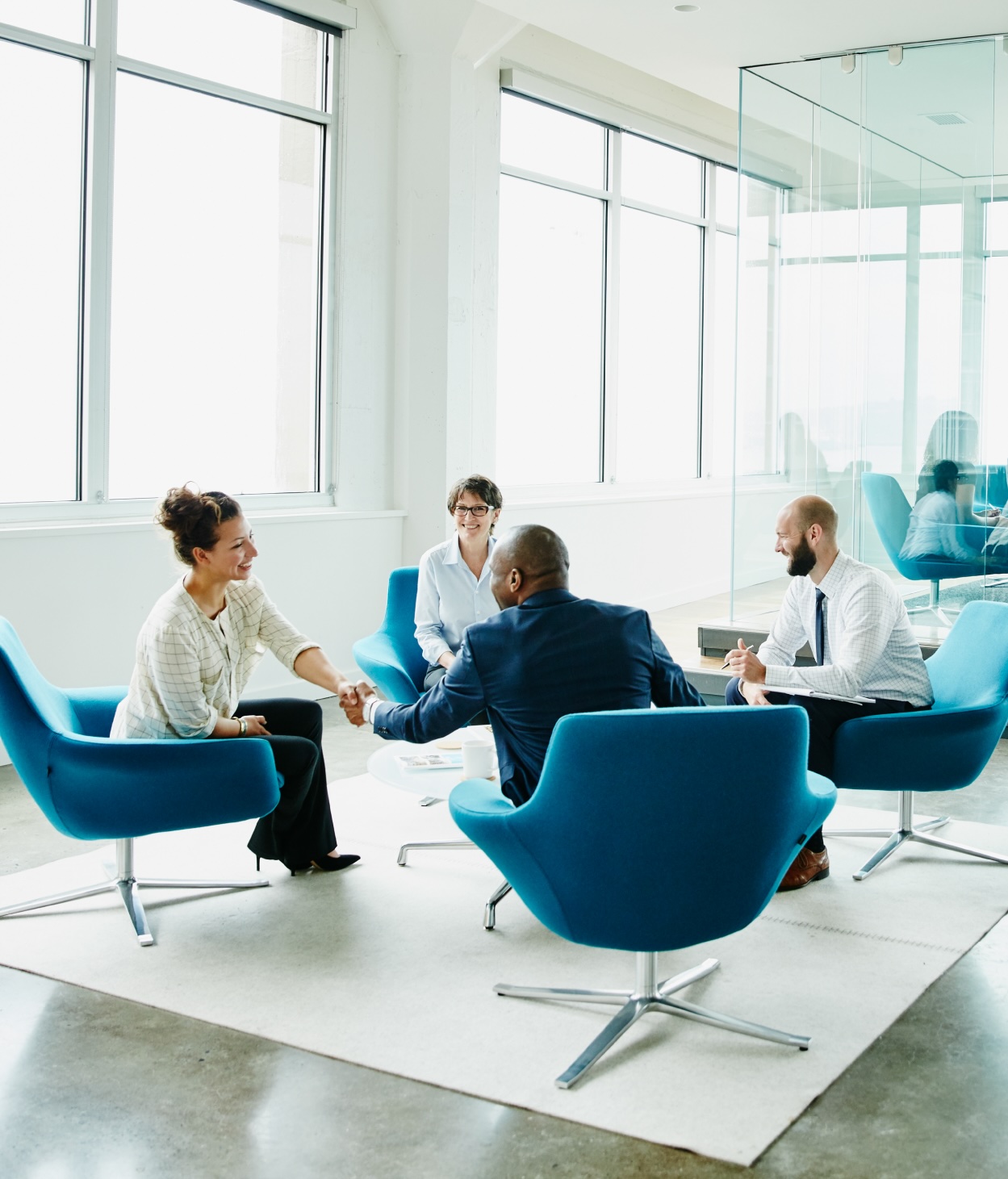 Privacy professionals meeting with clients in an office lounge.