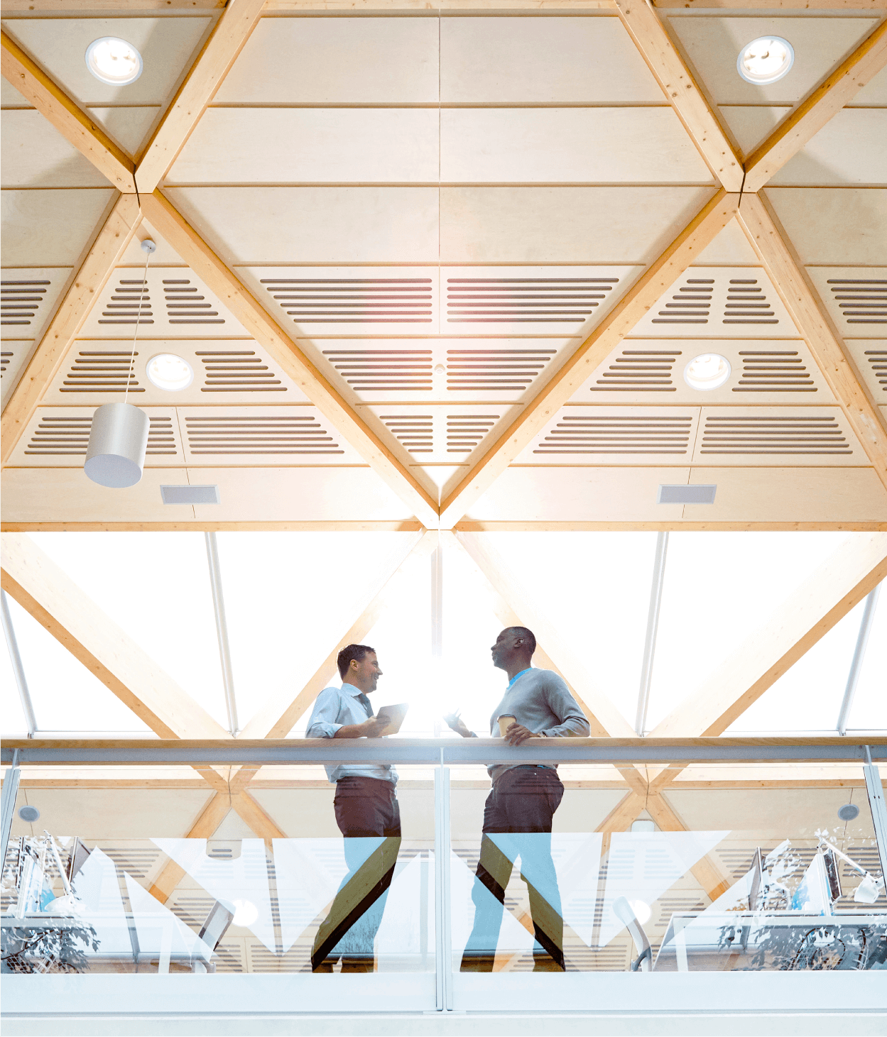 Low angle photo of two men talking on an office balcony