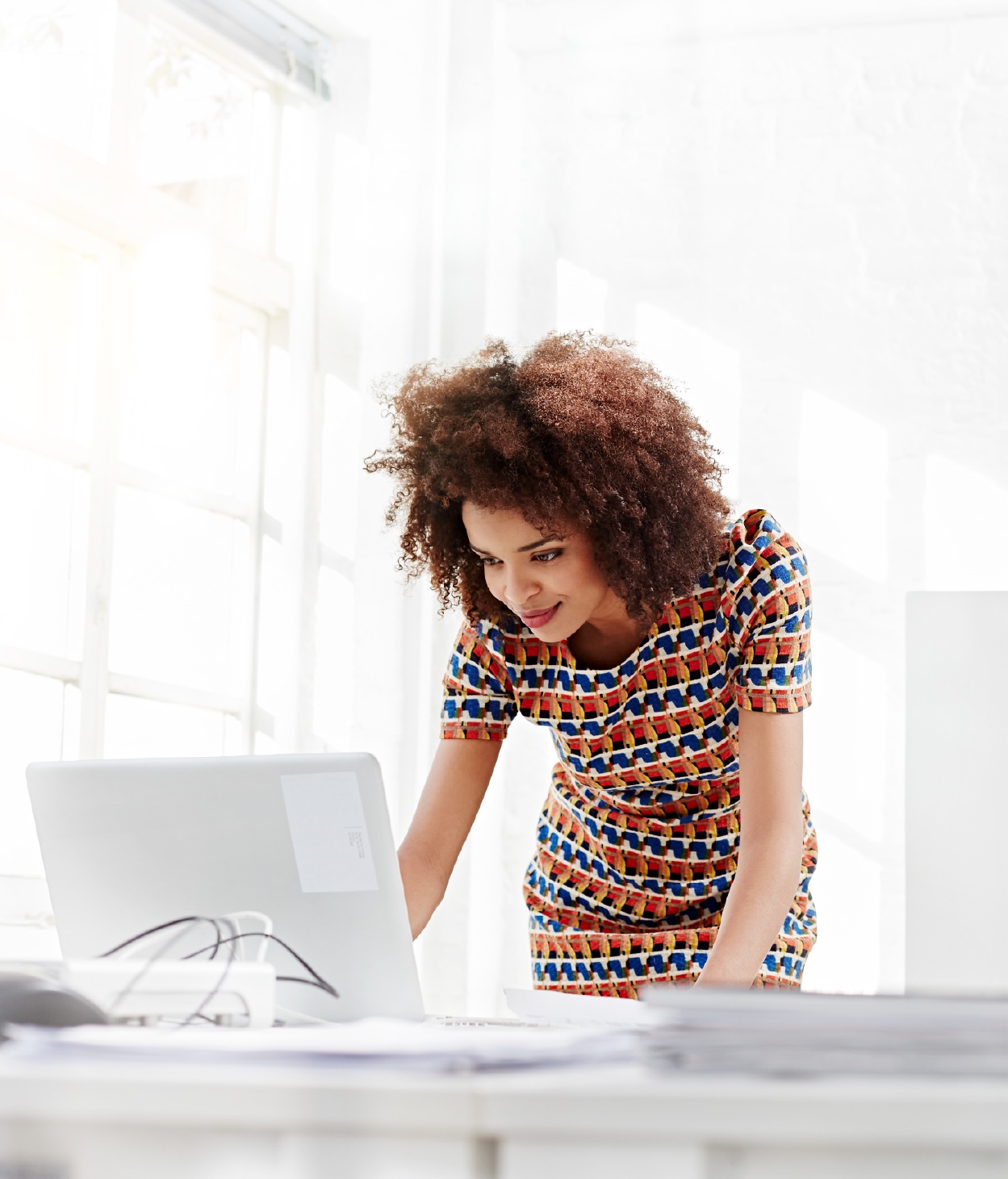 Woman working on her laptop in an office setting