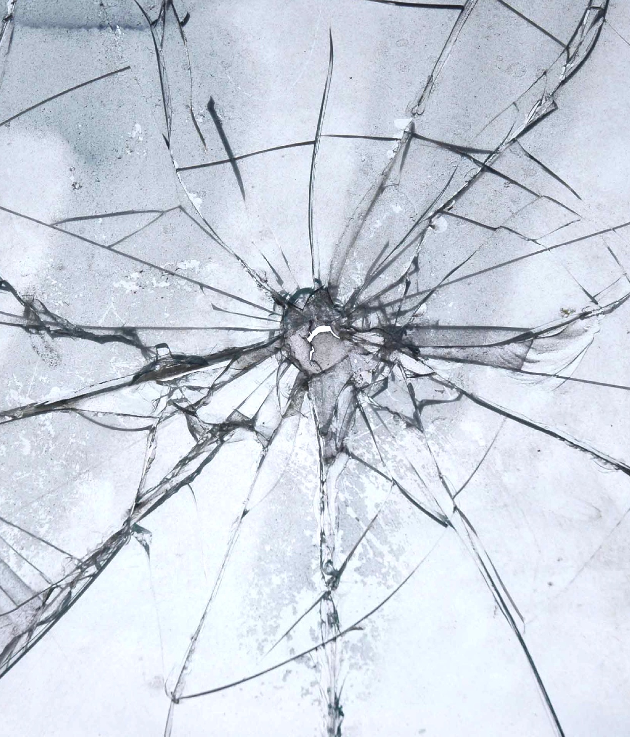 Bullet hole in cracked glass