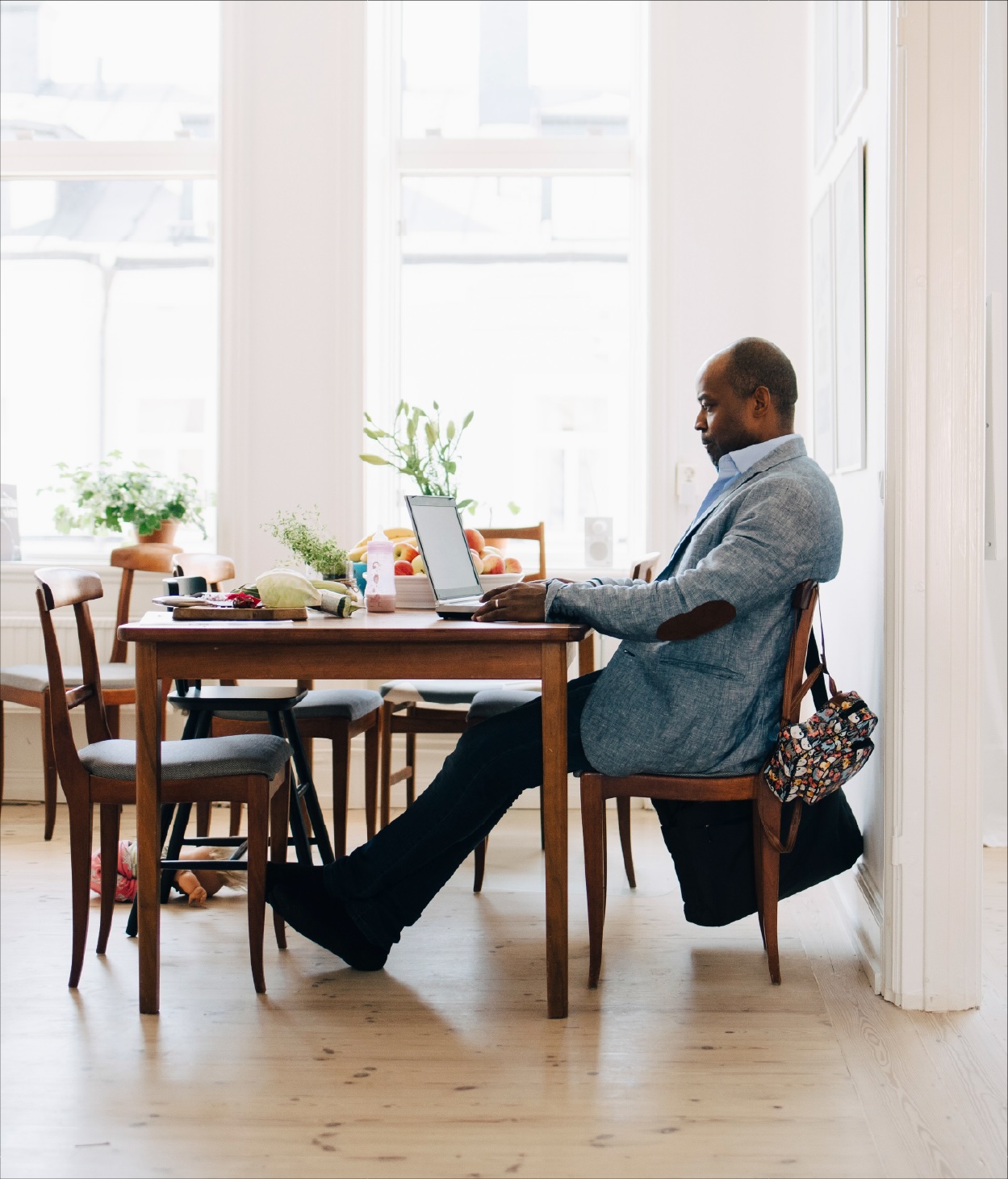 Businessman working remotely on his laptop from his dining table.