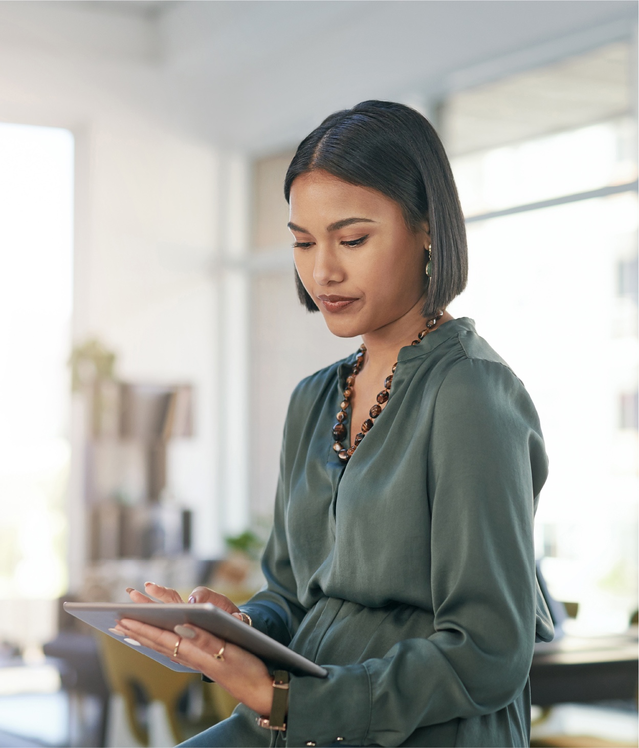 Businesswoman works on her tablet in her home office.