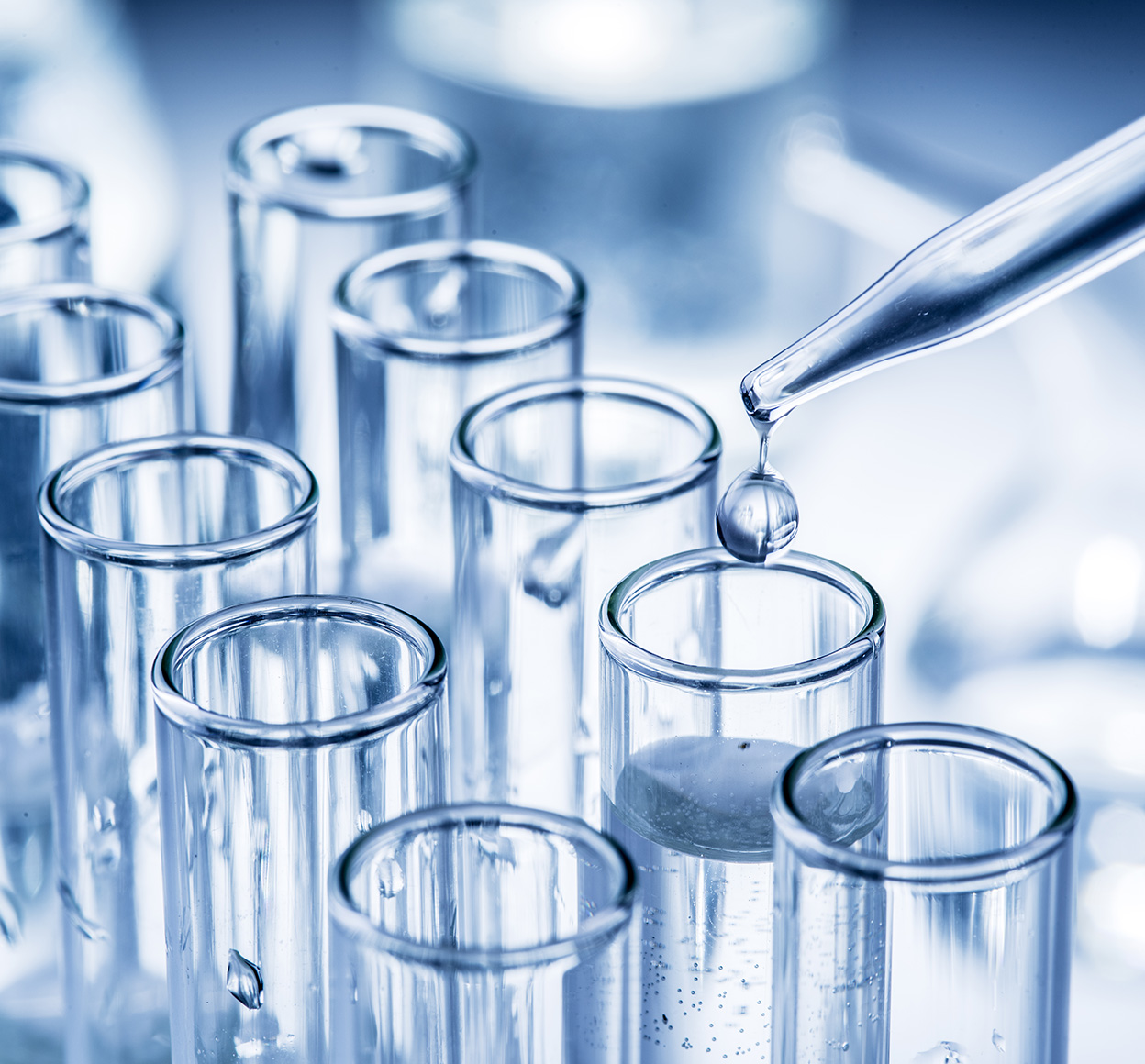 A chemical dropper leaves a droplet in a test tube