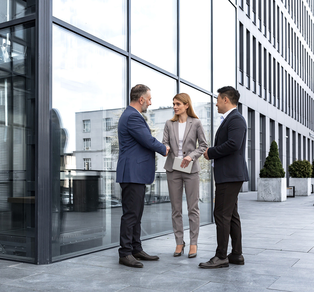 meeting of three colleagues from outside office building