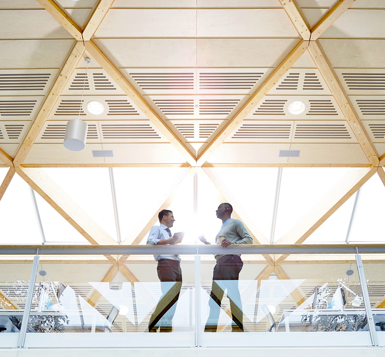 two people standing in a modern office