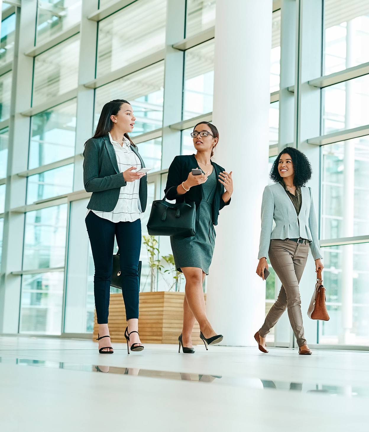 Young businesswomen walking though a convention center