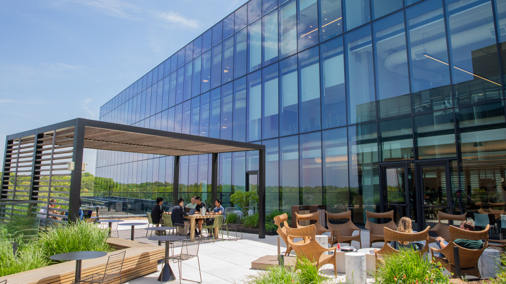 Photo of the exterior of the OneTrust Atlanta office with employees sitting on a patio