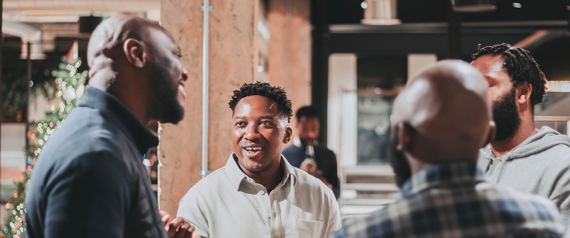 Black team members speaking with each other in an office.