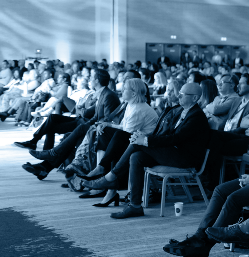 View of the audience listening intently at a TrustWeek presentation