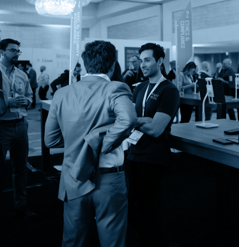 A OneTrust expert and a TrustWeek attendee chatting at the expert bar