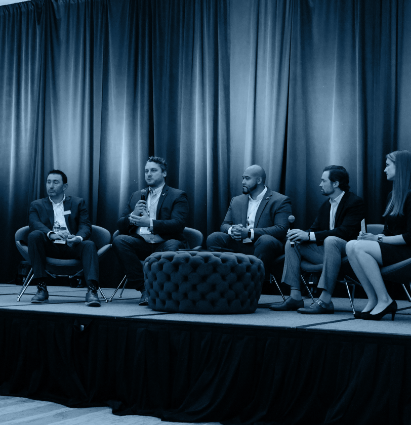 Panel of experts giving a roundtable talk on stage at TrustWeek