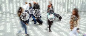 People made out of data bits are walking down a hallway. Some are highlighted with circles.