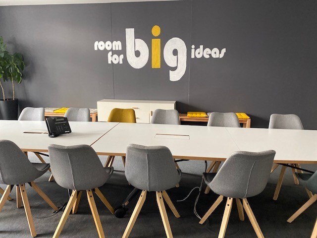 The inside of a meeting room for immowelt that says room for big ideas.