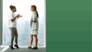 Two women discussing in front of an office window overlooking a city with OneTrust green to the right of the image.
