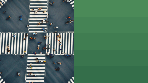A overhead view of a city crosswalk and the people passing over it.